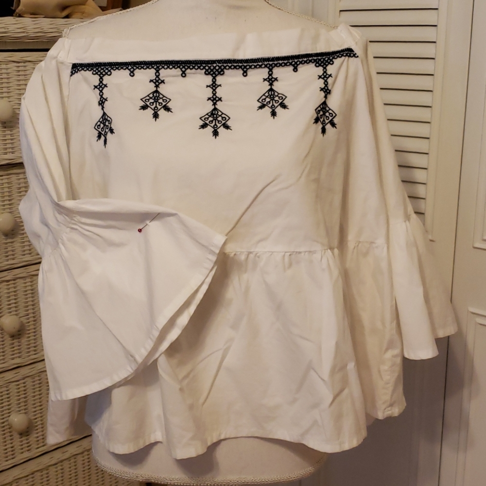 White shirt with blue embroidery